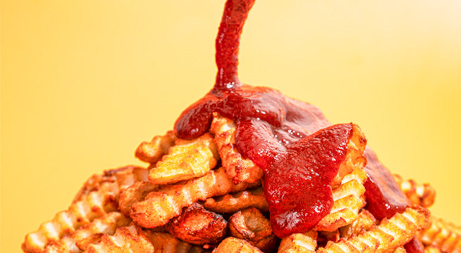Fries with KetchHot being drizzled on them