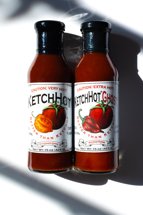 One each of a bottle of KetchHot and KetchHot Ghost on a white table